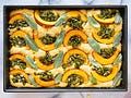 a casserole dish with yellow peppers and spinach