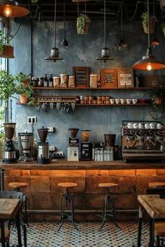 the interior of a coffee shop with lots of counter space and plants hanging from the ceiling