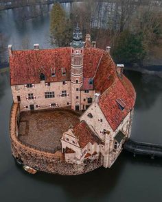 an aerial view of a castle in the water