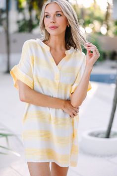 Feel confidently stylish in the Follow The Rules Yellow Striped Cover-Up. This fun tunic features chic yellow stripes and light fabric for a look that's comfortable and fashionable. Forego boring cover-ups in favor of this eye-catching cover-up! This cover-up features a v-neck, striped print, and short sleeves.  Material has no amount of stretch.Cam is wearing the small. Yellow V-neck Top For Beach Season, Striped Tops For Spring Beach Occasions, Spring Striped Beach Tops, Striped Beach Tops For Spring, Summer Beach Tops With Split Neck, Spring Beach Tunic With Split Neck, Summer Split Neck Top For Beach, Striped V-neck Summer Tops, Spring Beachy V-neck Tunic