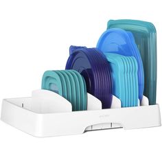 a white dish rack with blue and green dishes