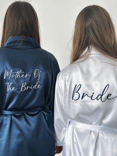 two women in robes with the words mother of the bride written on them, back to back