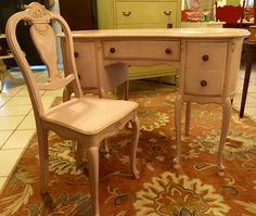 an antique desk and chair are on display in a room with other furniture, including chairs