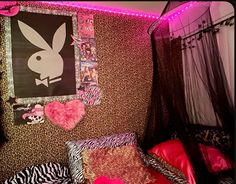 a bedroom with pink lights and animal prints on the walls