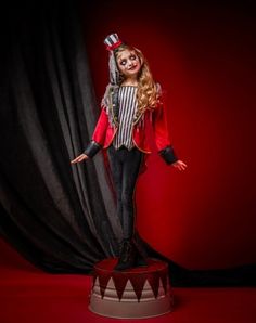 a woman dressed as a circus clown posing for the camera