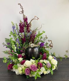 a vase filled with flowers sitting on top of a wooden table