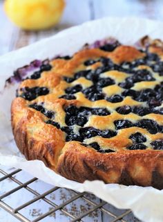 a blueberry pie sitting on top of a cooling rack