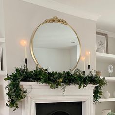 a living room with a fire place and a mirror on the wall above it's mantle