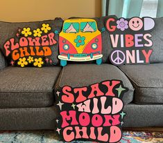 three pillows that say stay wild, hippie and flower child on a couch in front of a window