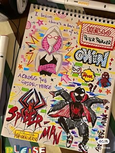 a spiral notebook covered in graffiti and stickers