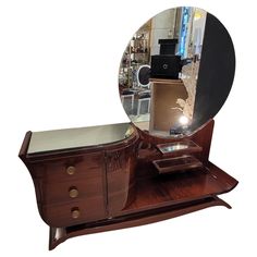 an old dresser with a mirror on it