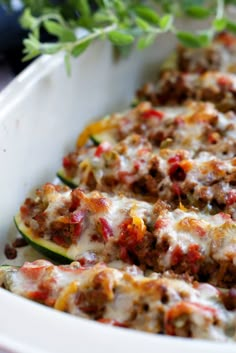 a casserole dish with meat, cheese and vegetables in it is ready to be eaten