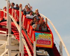 several people are riding on a roller coaster