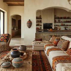 a living room filled with lots of furniture next to a fire place in a house