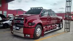 a large red truck parked in front of a building