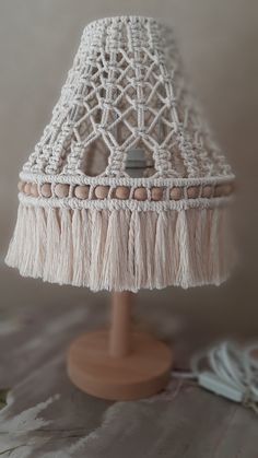 a white lamp with tassels on top of it