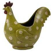 a green ceramic chicken with white polka dots