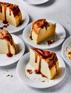 four slices of cake on white plates with caramel drizzle and chocolate sauce