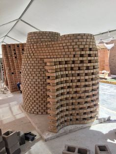 some bricks stacked on top of each other in a room with a white roof and walls