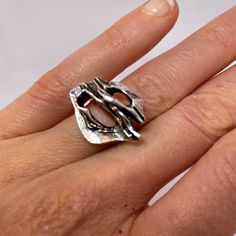 "A custom made designer mid century modernist ring in fine sterling silver.  This unique ring is in lovely condition and is absolute iconic of the era. Dating to the 1970s it could easily grace any coffee table book on fine jewelry design from the period.  In total it weighs 8.1 grams.  The face of the ring itself measures 11/16\" long by 15/16\" wide and rises 5/16\" high off the finger (18mm x 23mm x 8mm).  Currently this amazing hand made custom designed ring is a size 6 3/4. It can be resized to any size required at little cost.  This one of a kind modernist sterling silver ring will be sent in a presentation box." Luxury White Gold Modernist Rings, Modern Hallmarked Dome Ring For Promise, Modernist White Gold Ring For Gift, Modernist Open Band Rings For Formal Occasions, Modernist White Gold Rings For Gifts, Modernist White Gold Ring As Gift, Modernist White Gold Ring Gift, Contemporary Open Ring With Polished Finish, Modern Hallmarked Open Ring