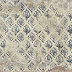 an old wallpaper with blue and white designs on the top, in front of a wooden floor