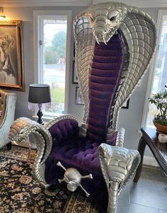 a living room filled with furniture and a large snake chair