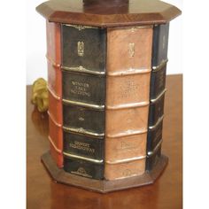 a stack of books sitting on top of a wooden table