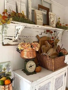 there is a shelf that has various items on it and an old clock next to it