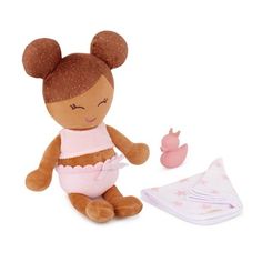 a brown teddy bear sitting next to a baby doll