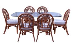 a dining room table with chairs and a glass top centerpiece on an isolated white background