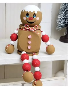 a gingerbread man sitting on top of a white shelf