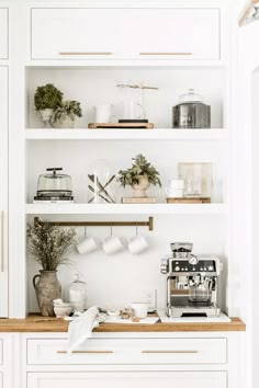 the shelves in this kitchen are filled with coffee and other things to make it look like they have been made out of wood