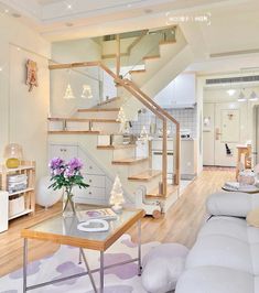 a living room filled with furniture and a staircase