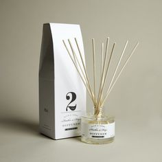 an image of a reed diffuser next to a box and package on the table