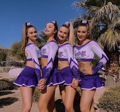 the cheerleaders are posing in their purple outfits