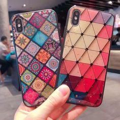 two colorful iphone cases sitting next to each other