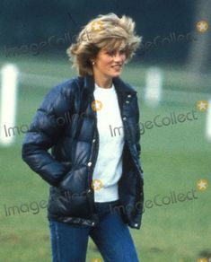 an older woman walking in the grass with her hands on her hips and looking back