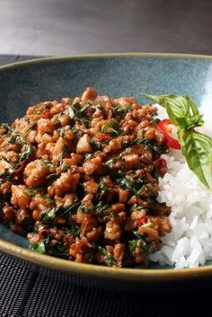 a bowl filled with rice and meat on top of a table