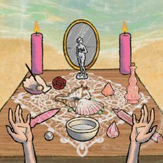 two hands reaching out towards a table with candles and other items on it in front of a mirror