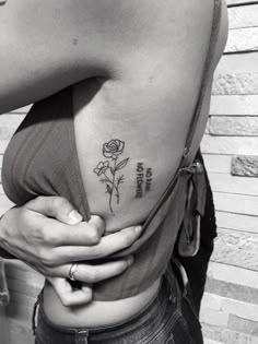 a woman with a rose tattoo on her left side ribcage and the words, i love you