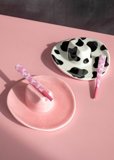 two pink and black plates with toothbrushes on them