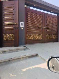 a car is parked in front of some wooden doors