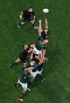 the rugby players are trying to catch the ball