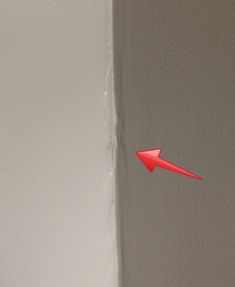 a red arrow sticking out of the side of a wall