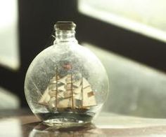 a glass bottle with a ship inside it