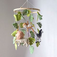 a mobile with animals and leaves hanging from it