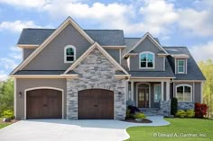 a large house with two garages on the front and one above the garage door