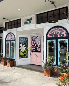 the entrance to and then is decorated with pink, blue, and green doors that have flowers on them