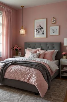 a bedroom with pink walls and gray bedding in the center is decorated with pictures on the wall