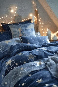 a bed with blue sheets and white stars on it